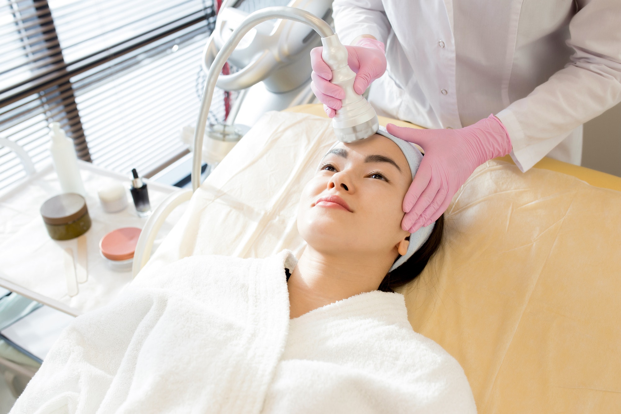 laser hair removal on patient face in clinic